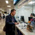 Traveller at airport currency exchange counter
