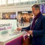 UK traveller exchanging currency at station desk