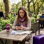 Traveler pays with phone at station café