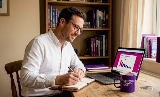 Man comparing exchange rates at home office desk