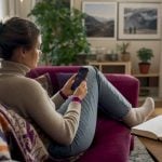 UK traveller using smartphone for rate alerts