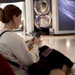 Woman managing currencies on travel card