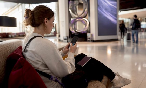 Woman managing currencies on travel card