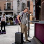 Traveler reviewing airport currency exchange rates