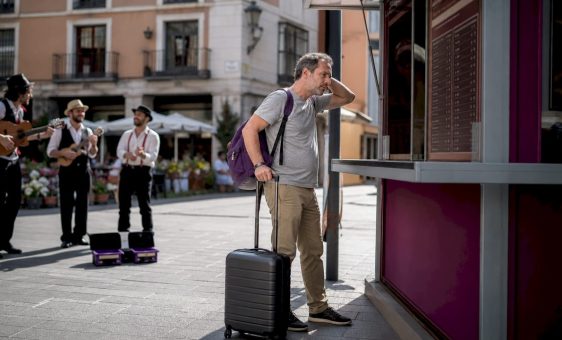 Traveler reviewing airport currency exchange rates
