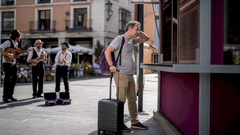 Traveler reviewing airport currency exchange rates