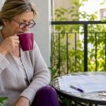 UK traveller reviewing currency charts at home