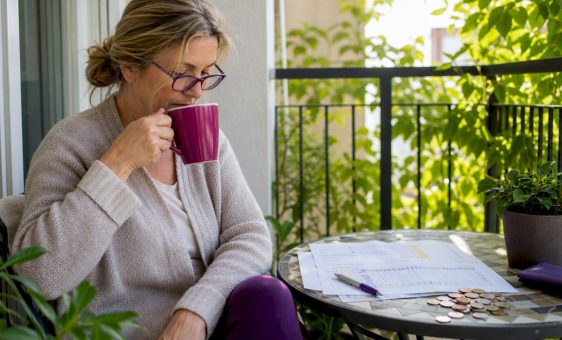 UK traveller reviewing currency charts at home