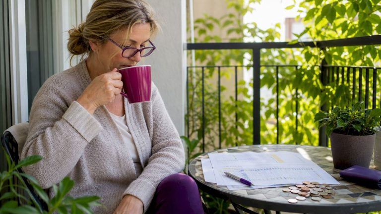 UK traveller reviewing currency charts at home