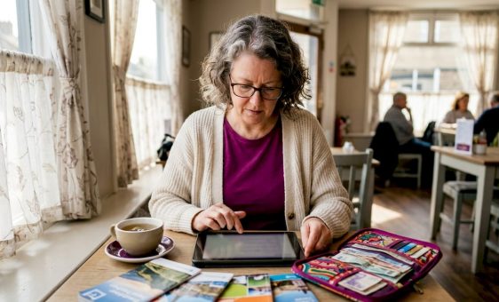 Woman checking currency rates at home