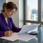Bank trader reviewing currency sheets