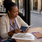 Traveller reviewing currency exchange documents outdoors