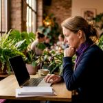 Person using currency comparison website at home